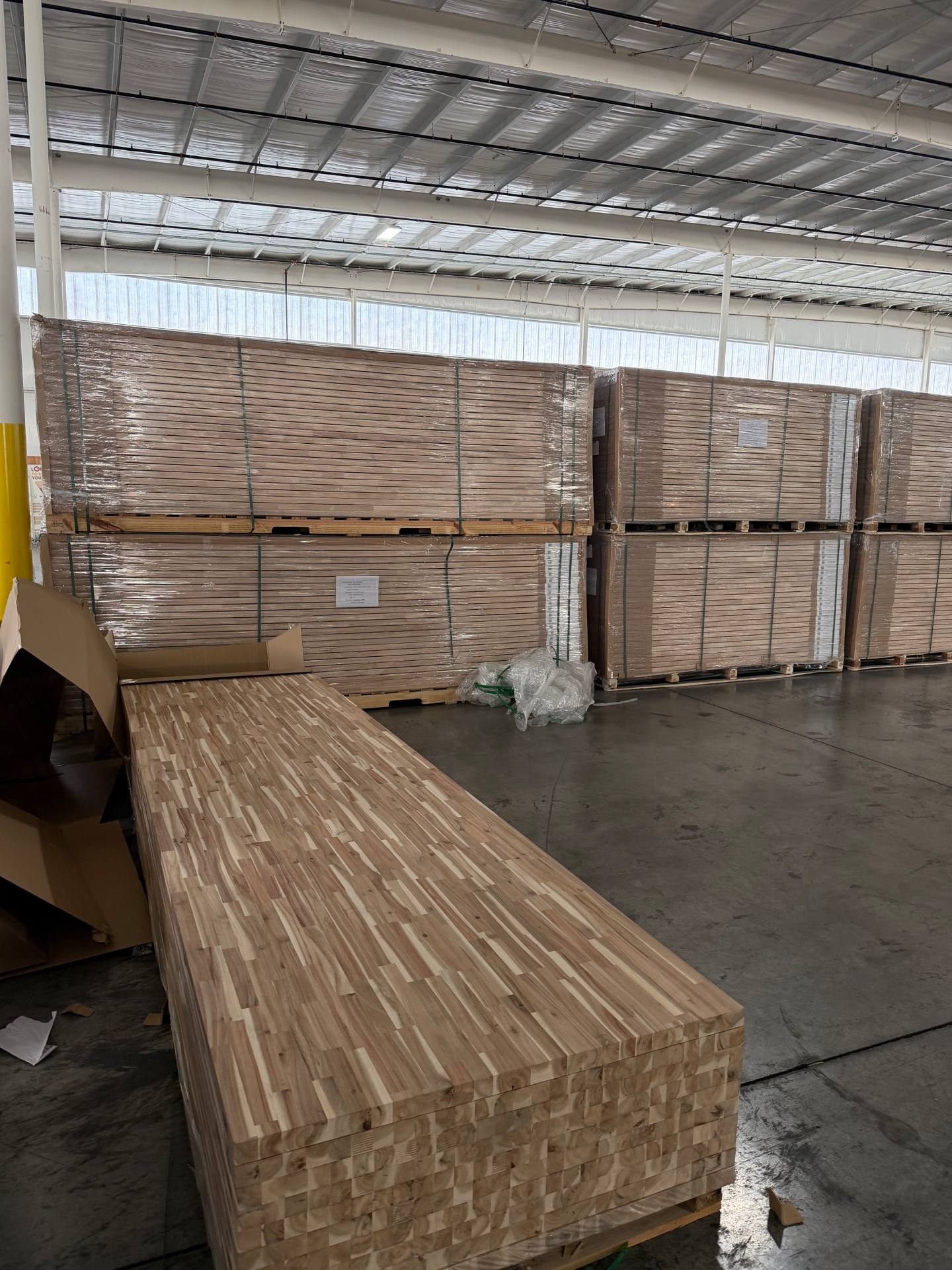 Warehouse inventory with butcher block slabs stacked on pallets