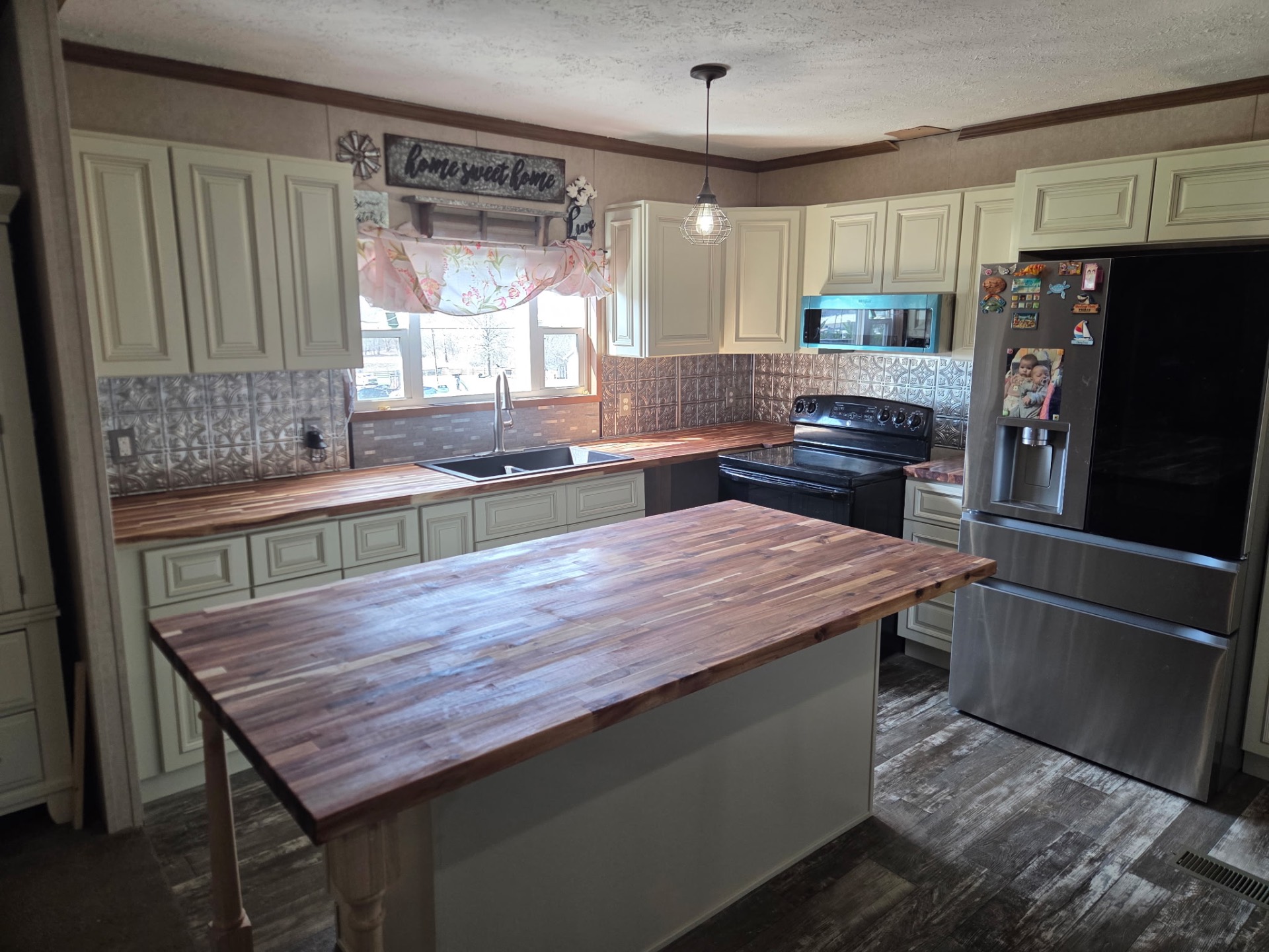 Cream kitchen with large butcher block island and matching counters