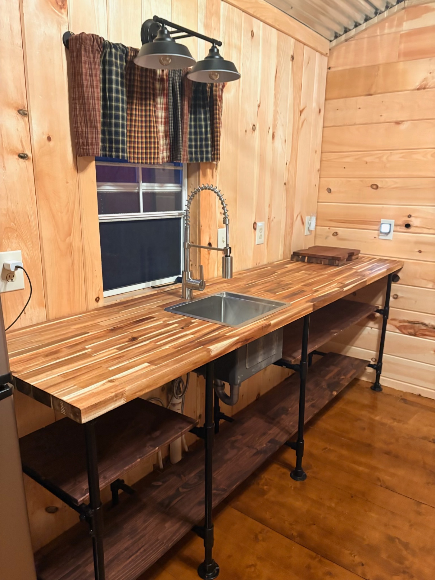 Rustic cabin-style utility sink with butcher block countertop