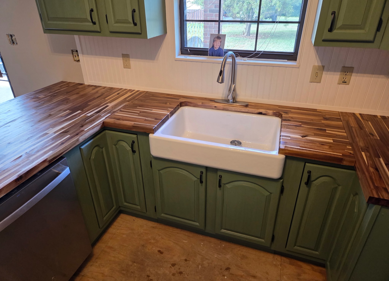 Farmhouse sink installation with acacia butcher block countertops